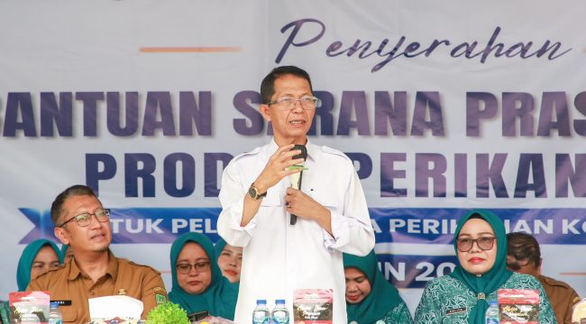 Wali Kota Batam, Amsakar Achmad, didampingi Ketua TP-PKK Batam, Erlita Amsakar, dan Kepala Dinas Perikanan Kota Batam, Yudi Atmajianto, menyampaikan sambutan saat penyerahan bantuan sarana dan prasarana kepada kelompok pengolah dan pemasaran hasil perikanan di Sagulung, Senin (14/9/2026). 